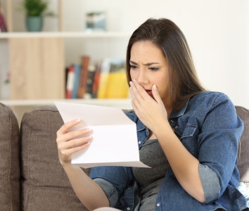 woman reading piece of paper