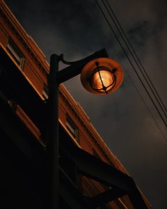 low-angle-shot-rusty-street-lamp-gray-sky