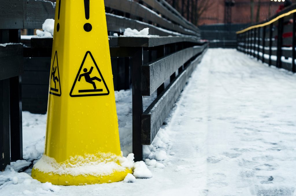 Slip and fall sign on the floor in the winter snow