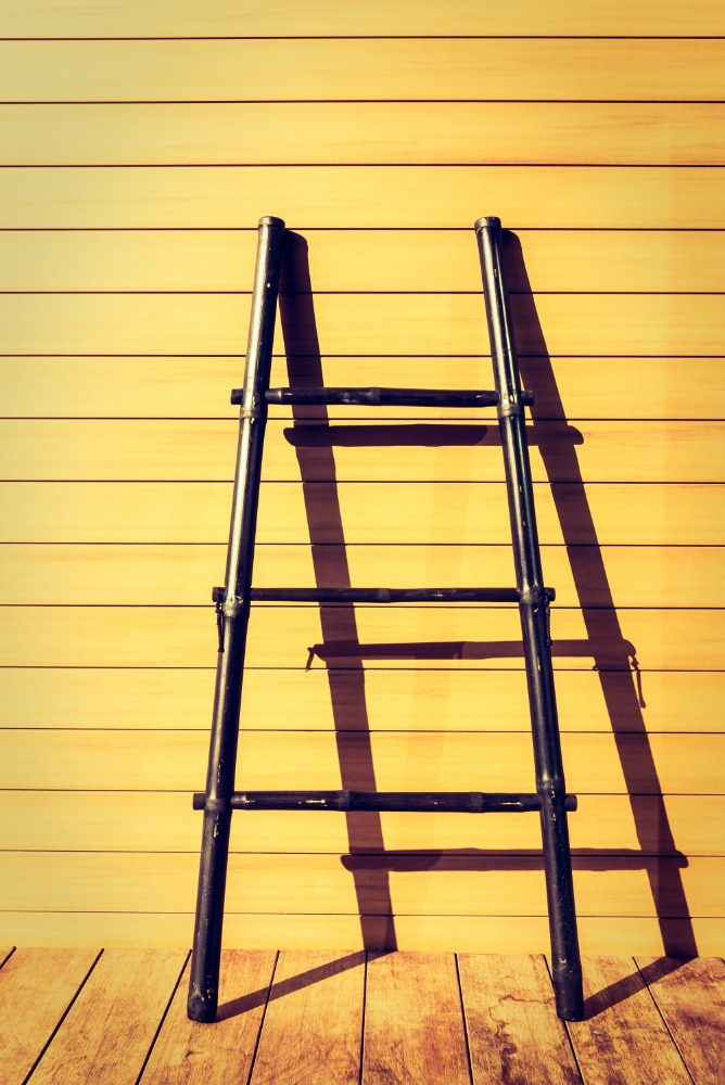 small ladder on a yellow wall